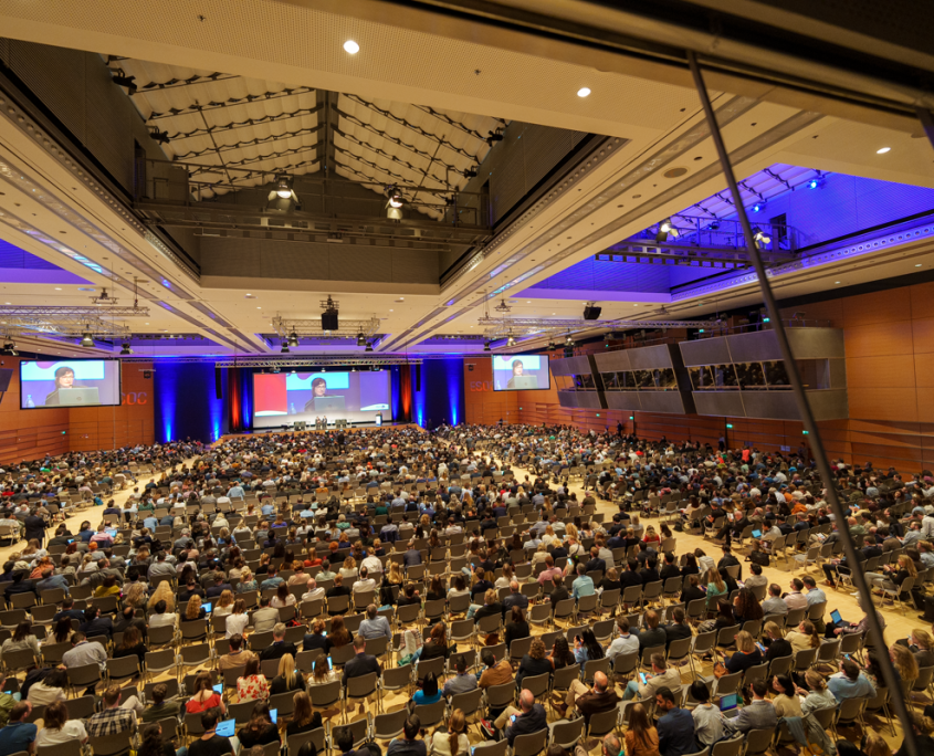 A full congress hall listening to a speaker